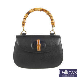 GUCCI - a vintage black leather bamboo handbag with hand mirror.