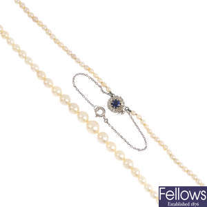 A cultured pearl single-strand necklace with a sapphire and diamond clasp.
