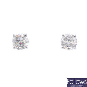A pair of brilliant-cut diamond stud earrings.