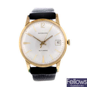 GARRARD - a gentleman's 9ct yellow gold wrist watch with an Omega watch head.