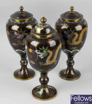 Three matched 20th century cloisonné urns and covers.