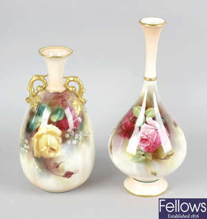 A Royal Worcester bone china vase, together with another similar vase, and a Royal Worcester bone china cauldron shaped twin handled vase and cover.