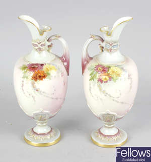 A pair of Royal Worcester ewers.