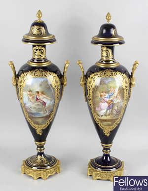A pair of Sevres style porcelain ormolu mounted twin handled vases and covers, together with a similar single vase.