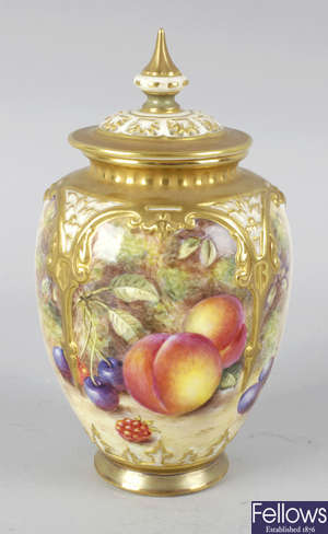 A Royal Worcester bone china vase with pierced cover.