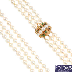 A cultured pearl three-row necklace, with emerald and cultured pearl clasp.
