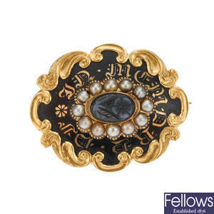 A late Victorian gold enamel, split pearl and onyx memorial brooch.