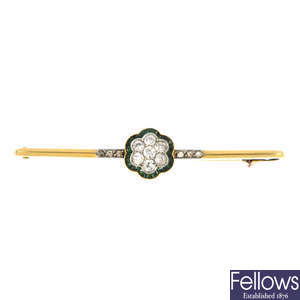 An early 20th century gold, diamond and emerald bar brooch.