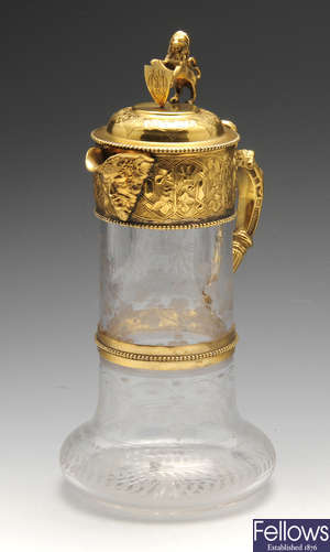 A continental glass claret jug with gilt mounts.