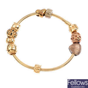 PANDORA and CLOGAU - a charm bracelet with nine charms.