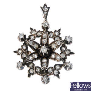 A diamond floral pendant.