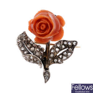 A coral and diamond flower brooch.