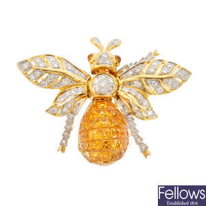 A diamond and citrine honey bee brooch.