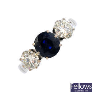 A sapphire and diamond three-stone ring.