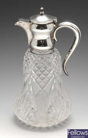An Edwardian silver mounted cut-glass jug.
