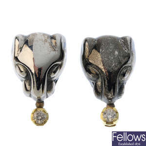 A pair of panther diamond earrings.