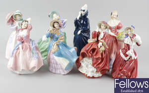 A group of eight Royal Doulton figurines.