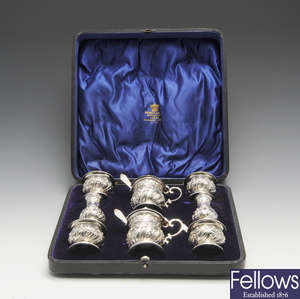 A cased Edwardian silver eight piece condiment set & Victorian condiment spoons.