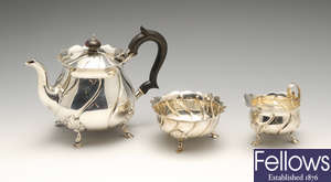 A late Victorian silver three piece bachelor tea service.