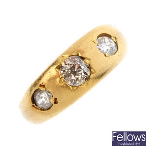A 9ct gold diamond three-stone band ring.