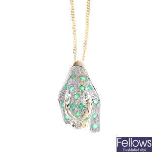 A 9ct gold emerald and diamond leopard pendant, with 9ct gold chain.