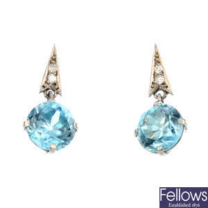 A pair of blue zircon and diamond earrings.