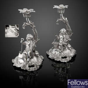 A pair of Victorian silver figural candlesticks in Rococo style.