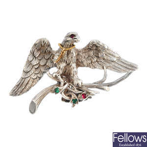 A gem-set eagle brooch.