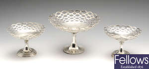 An early 20th century matched garniture of three silver pedestal dishes.