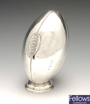 A modern Irish silver model of a rugby ball.