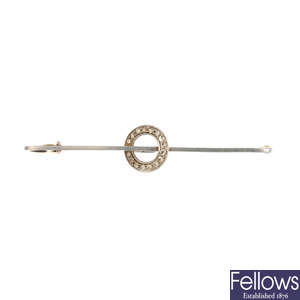 An early 20th century 15ct gold and platinum, diamond bar brooch.