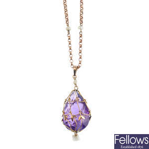An early 20th century 9ct gold amethyst and seed pearl pendant, with chain.