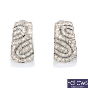 A pair of 9ct gold diamond half-hoop earrings.