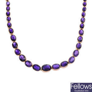 A late Victorian gold amethyst riviere necklace.