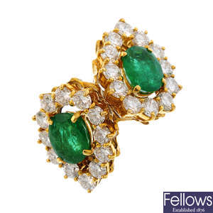 An emerald and diamond twin cluster ring.