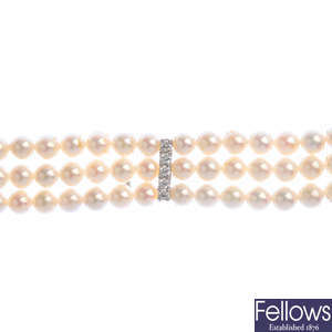 A cultured pearl and diamond three-row necklace.