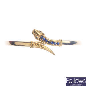 A 9ct gold gem-set snake bangle and a chain.