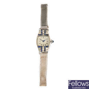 An early 20th century platinum sapphire and diamond cocktail watch.