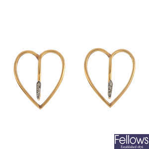 A pair of early 20th century gold and diamond lapel clips.