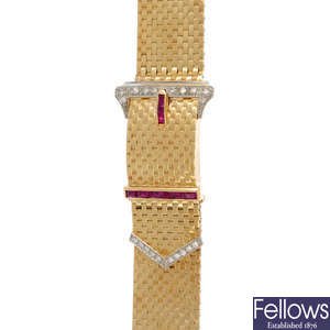 A 1940s gold, diamond and ruby buckle bracelet watch.