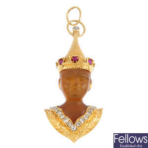 A carved gem-set figural pendant, with chain.