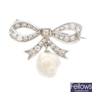 A diamond bow brooch with natural pearl drop.