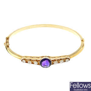 An early 20th century amethyst and diamond hinged bangle.