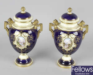 A pair of Coalport urns and covers.