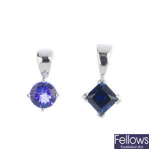 Two gem-set single-stone pendants.