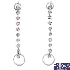 A pair of diamond drop earrings.