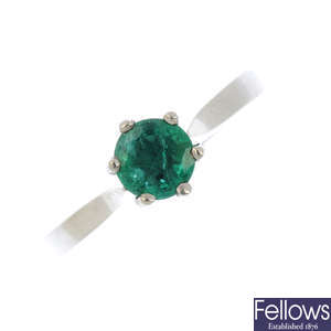 A platinum emerald single-stone ring.