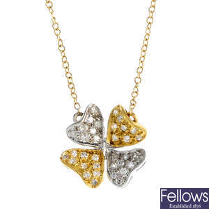 A gold diamond clover necklace.