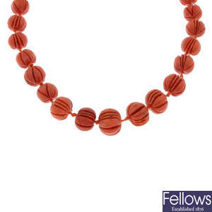 A carved coral bead necklace.