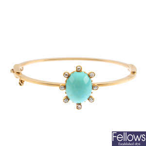 An early 20th century gold turquoise and diamond hinged bangle.